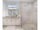 Elegant bathroom featuring a frameless shower and granite countertop at 10564 Royal Cypress Way, Orlando, FL 32836