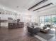 Open floorplan showcasing kitchen, living, and dining areas with wood beams and tile floors at 10564 Royal Cypress Way, Orlando, FL 32836