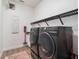 Convenient laundry room with modern washer and dryer and ample shelving at 10564 Royal Cypress Way, Orlando, FL 32836