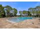 Community pool with a large patio and tranquil lake views at 10564 Royal Cypress Way, Orlando, FL 32836