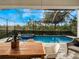 Relaxing poolside patio with outdoor dining furniture and a screened enclosure at 10564 Royal Cypress Way, Orlando, FL 32836