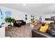 Open living room with sofas and view into kitchen and backyard at 11648 Paragraph Rd, Orlando, FL 32832