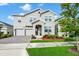 Two story home with two car garage and landscaped yard at 11648 Paragraph Rd, Orlando, FL 32832