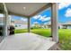 Covered patio with a grill overlooks a spacious backyard at 11648 Paragraph Rd, Orlando, FL 32832