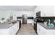 Modern kitchen with white cabinets, stainless steel appliances and a large island at 11648 Paragraph Rd, Orlando, FL 32832