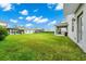 Large backyard with grassy area and covered patio at 11648 Paragraph Rd, Orlando, FL 32832
