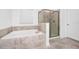 Clean bathroom with a soaking tub and a walk-in shower at 11648 Paragraph Rd, Orlando, FL 32832