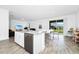 Eat-in kitchen with island, stainless steel appliances, and backyard access at 11648 Paragraph Rd, Orlando, FL 32832