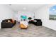 Living room with two black sofas and yellow accent chair at 11648 Paragraph Rd, Orlando, FL 32832