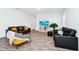 Living room with two black sofas and yellow accent chair at 11648 Paragraph Rd, Orlando, FL 32832