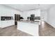 White kitchen with stainless steel appliances and an island at 11648 Paragraph Rd, Orlando, FL 32832