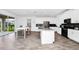 Spacious kitchen with island, stainless steel appliances, and view to backyard at 11648 Paragraph Rd, Orlando, FL 32832