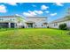 Spacious backyard with home and solar panels visible at 11648 Paragraph Rd, Orlando, FL 32832