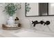 Vanity with marble countertop, black faucets, and a wooden cabinet at 1206 Sutter Ave, Gotha, FL 34734