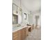 Double vanity bathroom with marble countertops and gold fixtures at 1206 Sutter Ave, Gotha, FL 34734