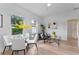 Bright dining area with glass table and four white chairs at 1795 Walker Ave, Winter Park, FL 32789