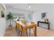 Bright dining room with wood table and mustard yellow chairs at 1795 Walker Ave, Winter Park, FL 32789