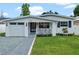 Charming single story home with a modern white exterior and landscaped lawn at 1795 Walker Ave, Winter Park, FL 32789