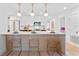 Modern kitchen with a breakfast bar, white cabinets and gold fixtures at 1795 Walker Ave, Winter Park, FL 32789