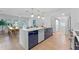 Modern kitchen with a large island, white and blue cabinets, and gold accents at 1795 Walker Ave, Winter Park, FL 32789
