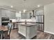 Modern kitchen featuring granite countertops, stainless steel appliances, and gray cabinetry at 3286 Hanging Tide St, Winter Garden, FL 34787