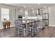 Kitchen with gray cabinets, granite countertops, and a kitchen island at 3286 Hanging Tide St, Winter Garden, FL 34787