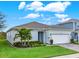 Single story house with light blue exterior, gray roof and landscaped front yard at 3286 Hanging Tide St, Winter Garden, FL 34787