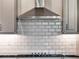 Stainless steel range hood above gas cooktop with white subway tile backsplash at 3286 Hanging Tide St, Winter Garden, FL 34787