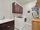 Laundry room with washer, dryer, and ample cabinet space at 3286 Hanging Tide St, Winter Garden, FL 34787