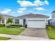 Single-story house with light blue exterior, gray roof and landscaped front yard at 3286 Hanging Tide St, Winter Garden, FL 34787