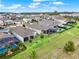 Aerial view of homes with pools and lush landscaping near a lake in Florida at 3286 Hanging Tide St, Winter Garden, FL 34787