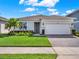 Single-story home with gray exterior, white garage door, and landscaped front yard at 3286 Hanging Tide St, Winter Garden, FL 34787