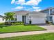 Single-story house with gray siding, white garage door, and well-manicured lawn at 3286 Hanging Tide St, Winter Garden, FL 34787