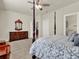 Well-lit bedroom with a dresser and a comfortable post bed at 3286 Hanging Tide St, Winter Garden, FL 34787
