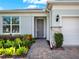 Charming house exterior with gray door and well-maintained landscaping at 3286 Hanging Tide St, Winter Garden, FL 34787