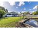 Backyard with grassy area, pond, and fire pit at 4801 Beach Blvd, Orlando, FL 32803
