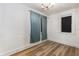 Simple bedroom with light walls and laminate wood floor at 4801 Beach Blvd, Orlando, FL 32803