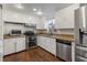 L-shaped kitchen with stainless steel appliances and wood look flooring at 4801 Beach Blvd, Orlando, FL 32803