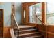 Elegant wooden staircase with wrought iron railings in a spacious entryway at 4801 Beach Blvd, Orlando, FL 32803