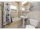 Clean bathroom with a pedestal sink, bathtub, and shower at 4801 Beach Blvd, Orlando, FL 32803