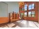 Spacious living area with wall of windows, hardwood floors, and unique chandelier at 4801 Beach Blvd, Orlando, FL 32803