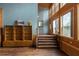 Bright entryway with wooden staircase, wood-paneled walls, and hardwood floors at 4801 Beach Blvd, Orlando, FL 32803