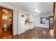 Open kitchen with breakfast bar, white cabinets, and a full bathroom with updated vanity at 4801 Beach Blvd, Orlando, FL 32803
