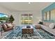 Bright living room featuring a cozy sectional sofa and a large window at 684 Preston Cove Dr, St Cloud, FL 34771