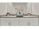 Double vanity bathroom with granite countertop and large mirror at 684 Preston Cove Dr, St Cloud, FL 34771