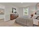 Bright bedroom featuring a comfortable bed and en-suite bathroom at 684 Preston Cove Dr, St Cloud, FL 34771