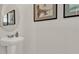 Simple bathroom with a pedestal sink and framed art at 684 Preston Cove Dr, St Cloud, FL 34771