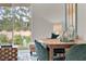 Casual dining area with wooden table and green velvet chairs at 684 Preston Cove Dr, St Cloud, FL 34771