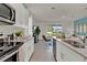 Modern kitchen with white cabinets, granite countertops and island at 684 Preston Cove Dr, St Cloud, FL 34771