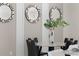 Round marble dining table with black chairs and stylish wall mirrors at 688 Preston Cove Dr, Saint Cloud, FL 34771